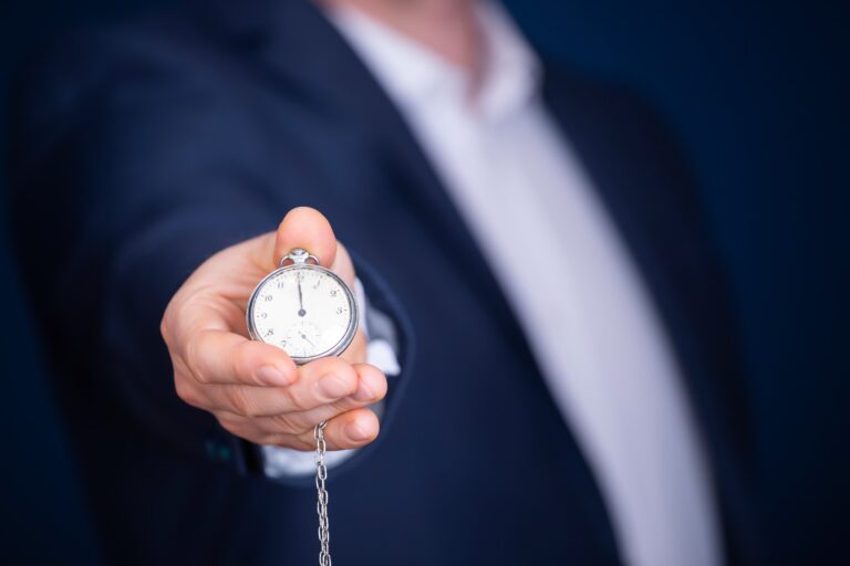 Businessman with clock in time concept